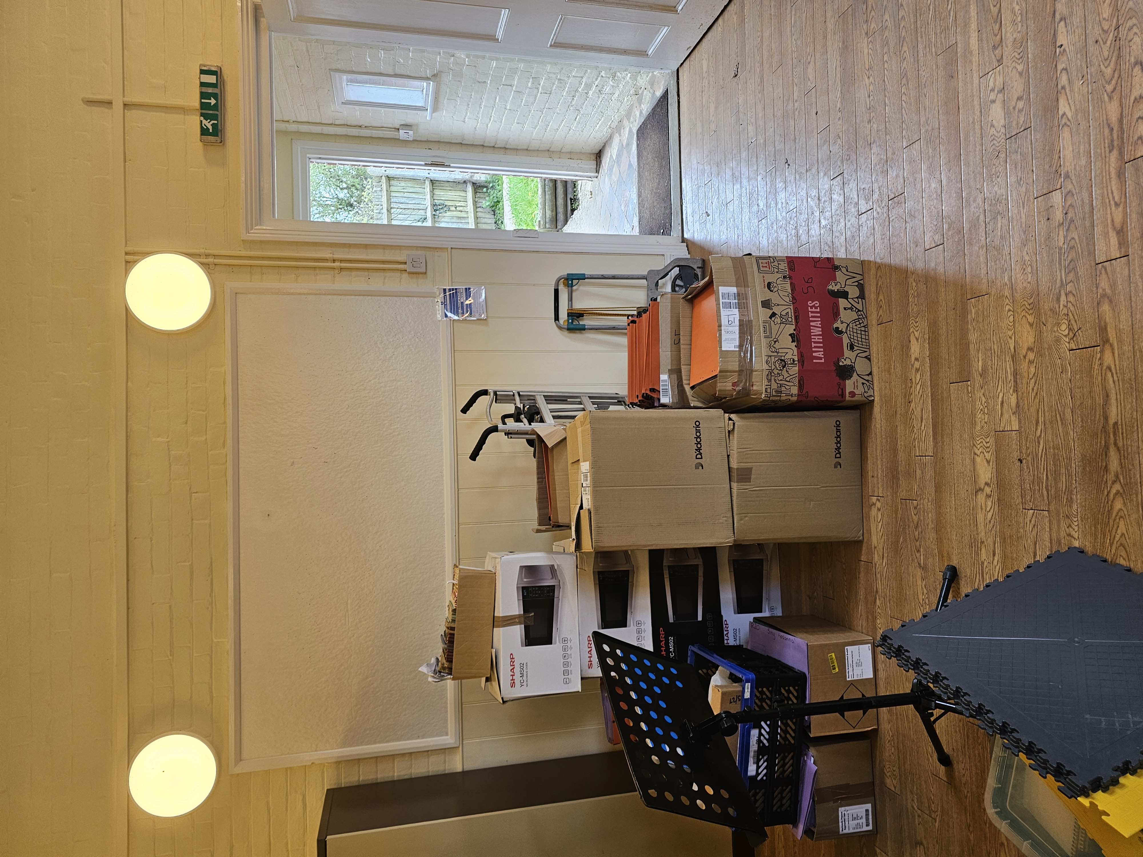 Boxes and music stands stacked in the hall